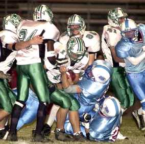 Thomas Lister (15) of Greeneville gets wrapped up by a Sullivan South defender